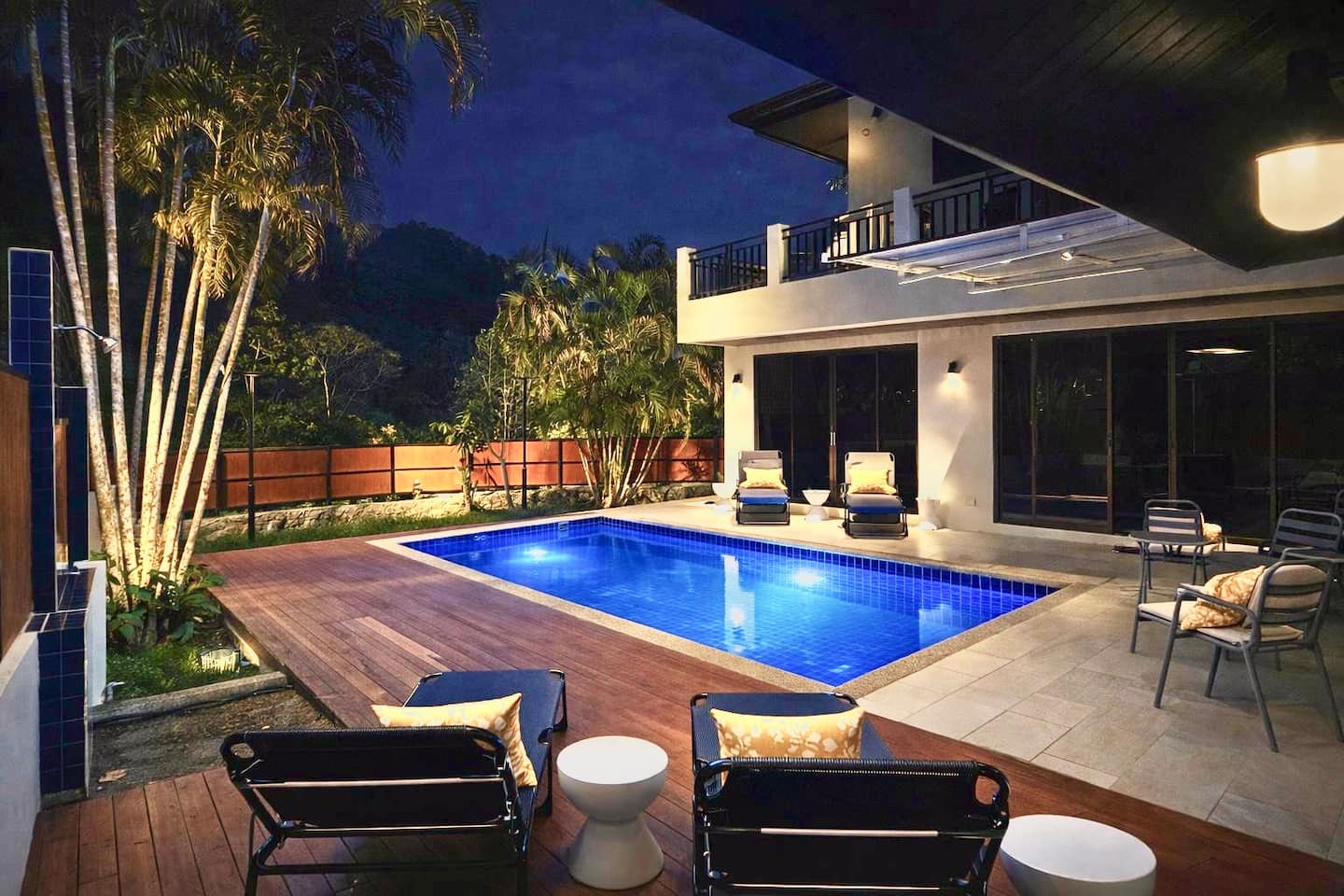 Pool villa with palms in Phuket at evening